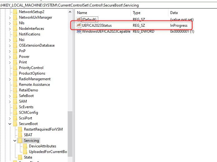Registry Editor showing HKLM\SYSTEM\CurrentControlSet\Control\SecureBoot\Servicing with UEFICA2023Status set to InProgress
